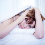 woman in bed with insomnia that can’t sleep white background