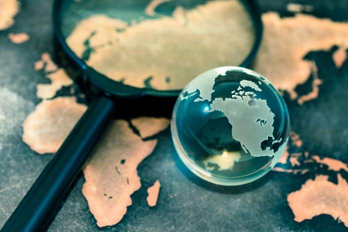 Crystal globe on grunge world map Fitbit Global Spying