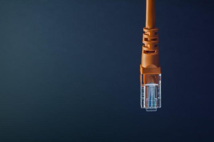 LAN connection orange plastic connector isolated on black background Airgap