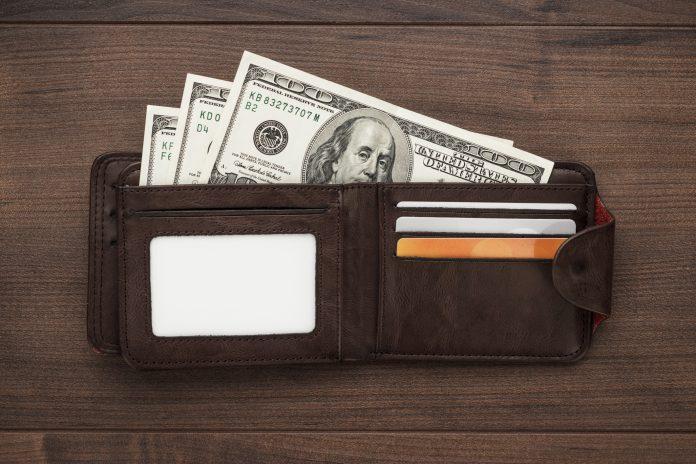 purse with money on the wooden table wallet