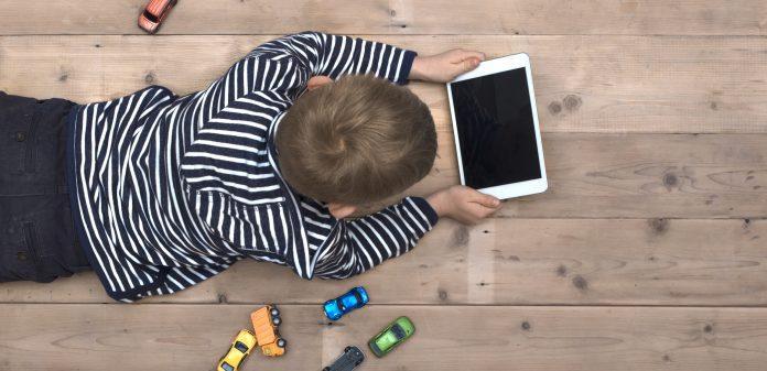 kid on floor with tablet pc children app