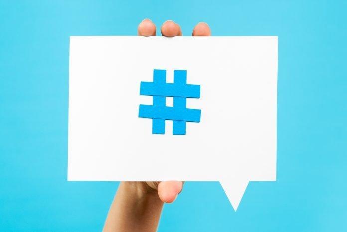 Hand showing internet social media trend topic hashtag speech bubble