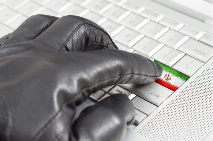 Hacking Iran concept with hand wearing black leather glove press Iranian hacking