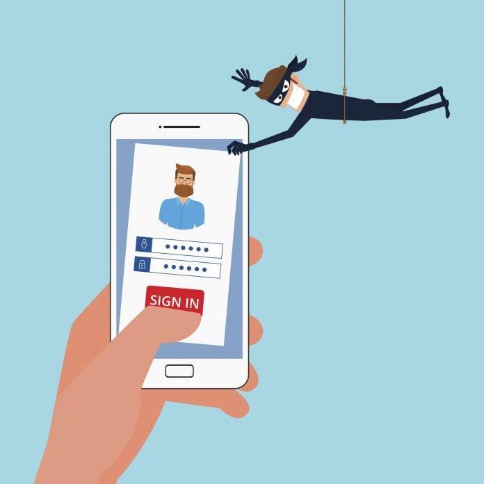 Thief Hacker stealing sensitive data, personal information as passwords from a smartphone useful for anti phishing and internet viruses campaigns.Concept hacking internet social network.