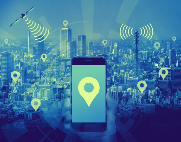 duo tone graphic of smart city and smart phone application using location information, hand hold smart phone communicating with satellite and wireless communication antenna, abstract image visual Location tracking