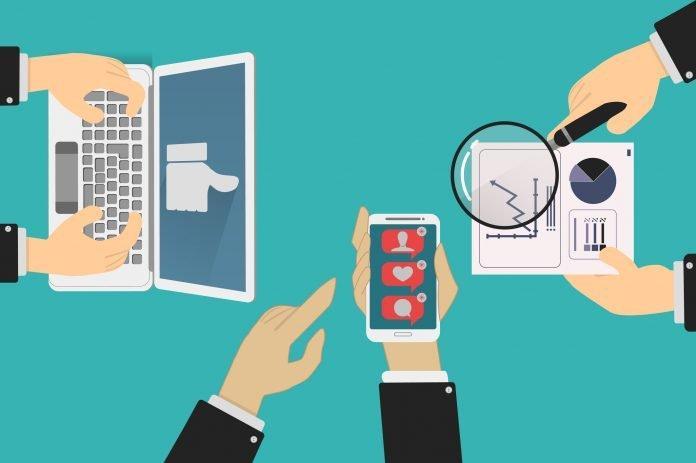 community managers team posts on social networks and analyze stats of results of marketing campaigns. online advertising